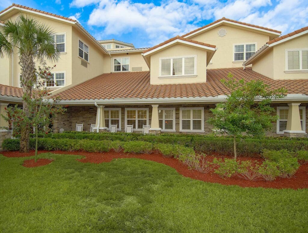 Exterior shot of Windward Palms exterior porches with rocking chairs.