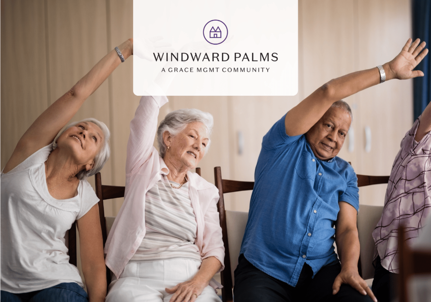 Four seniors seated, raising arms in a group stretch at Windward Palms (a Grace MGMT Community).