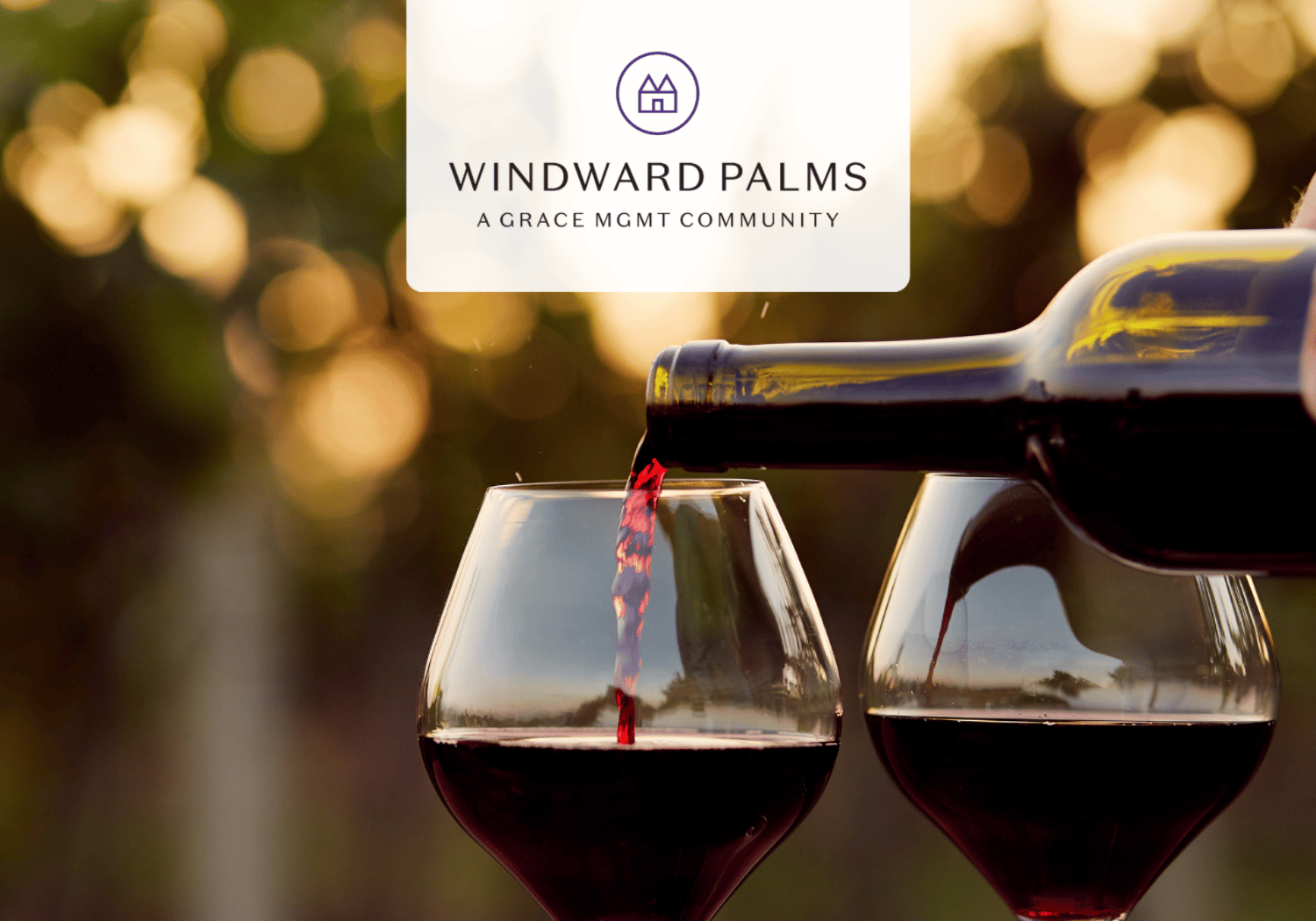 Two wine glasses are being filled from a bottle, with a blurred sunset background and a Windward Palms logo centered above.
